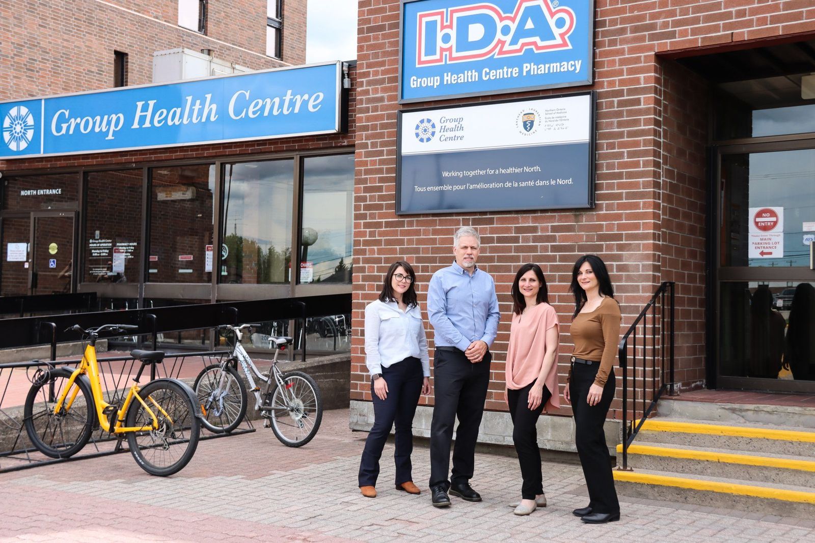 Four members of the pharmacy team outside Group Health Centre I.D.A. Pharmacy on McNabb Street